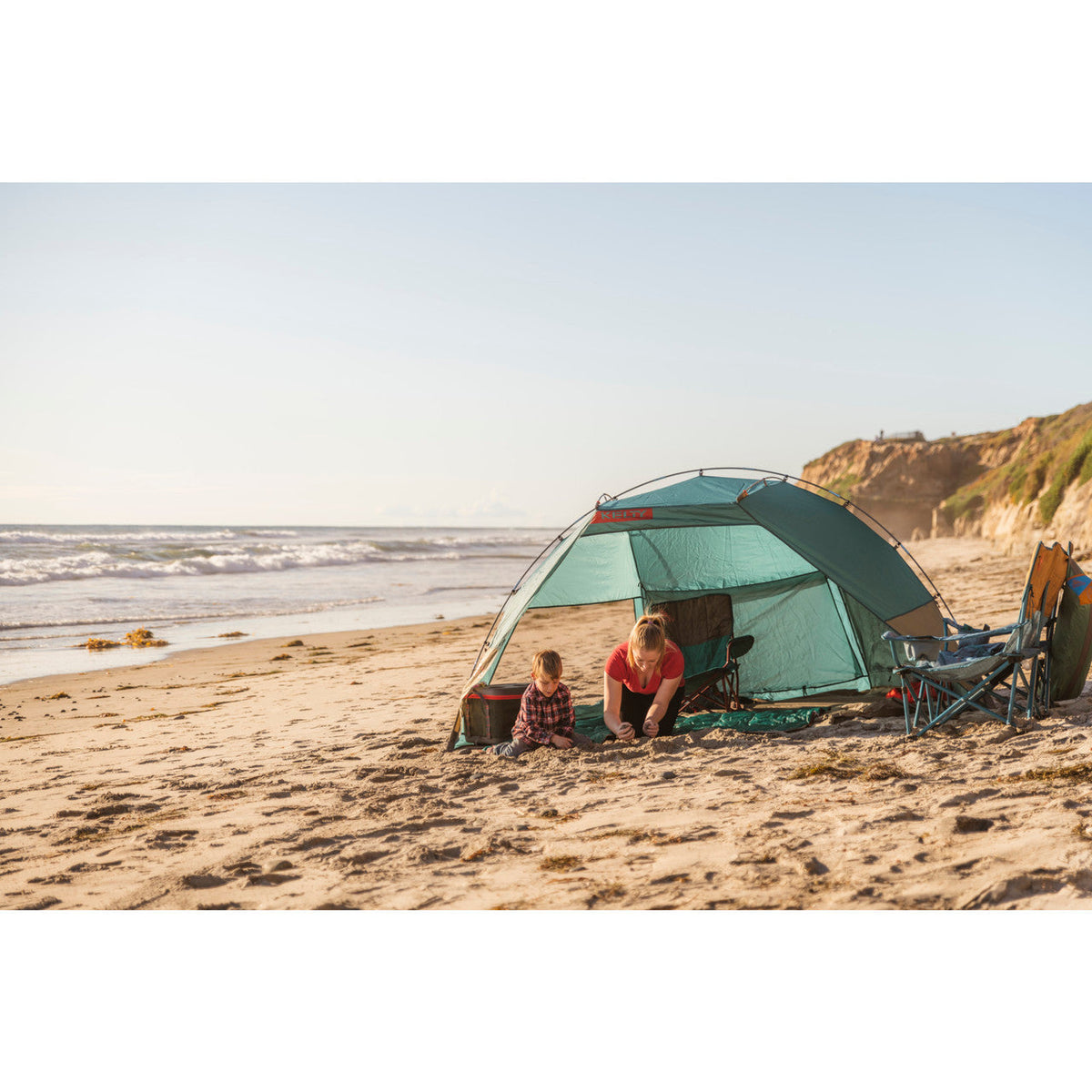 Mother and child at beach enjoying the Cabana shelter.
