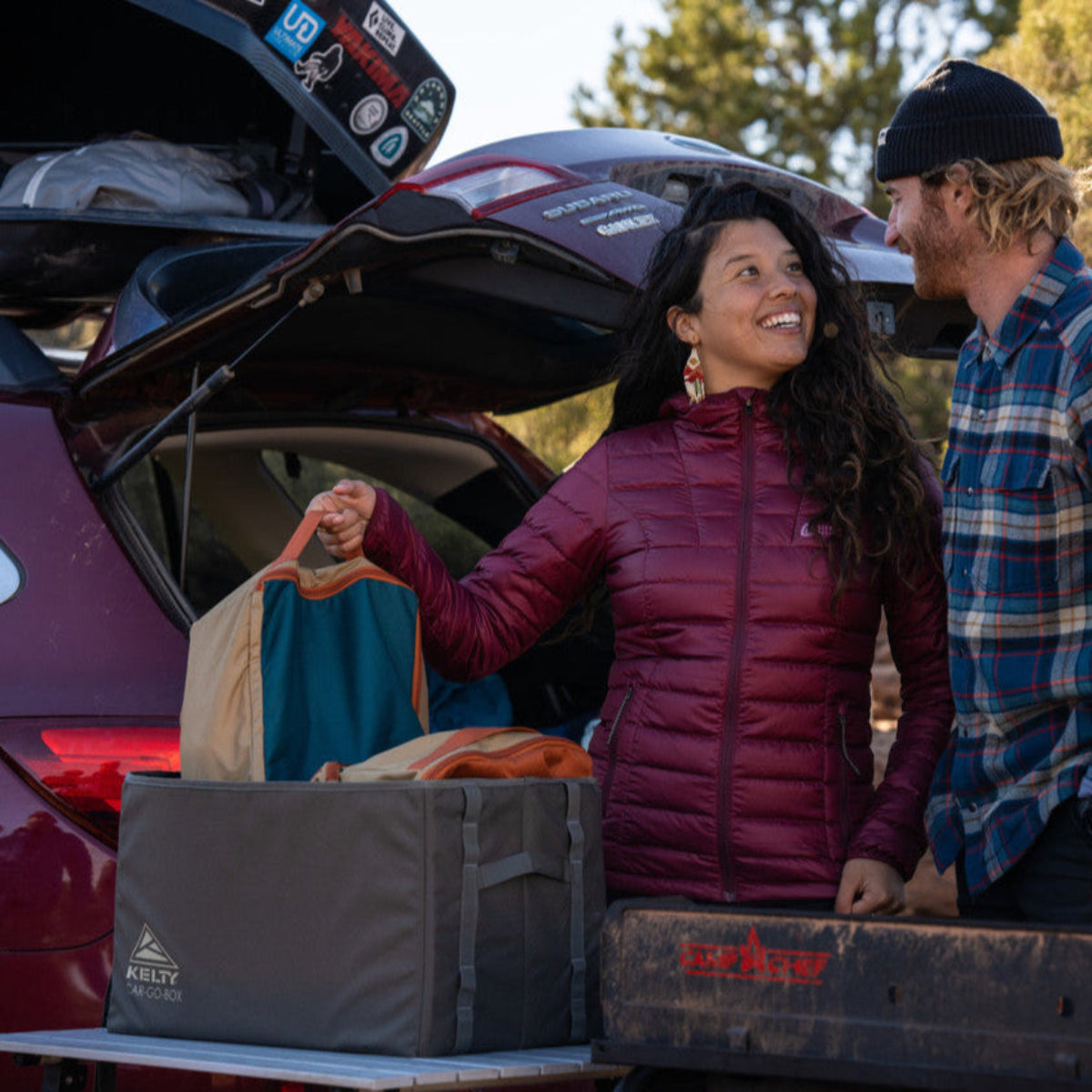 Couple with Kelty Car-Go-Box on the tailgate of their vehicle