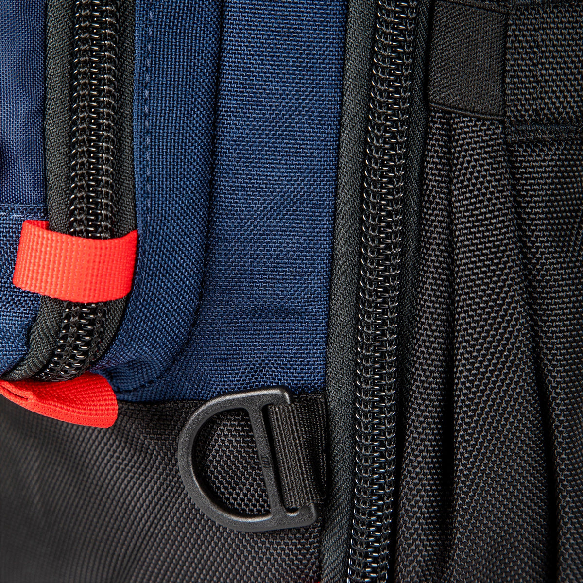 Topo Designs Global Travel Bag 30L Durable Carry On Convertible Laptop Travel Backpack in Navy blue showing attachment points and locking zippers.