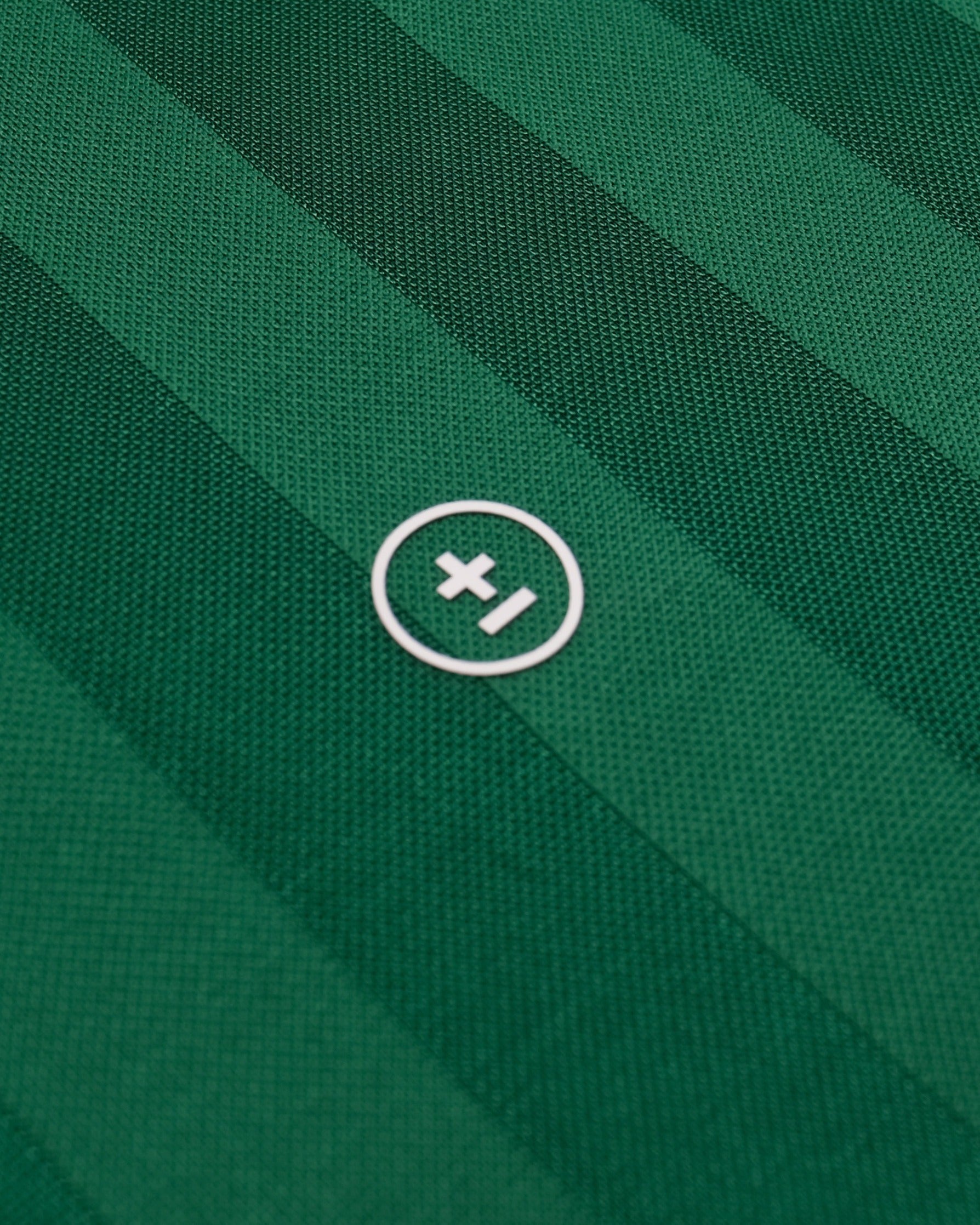 Close-up of a green fabric with a white logo on a green background