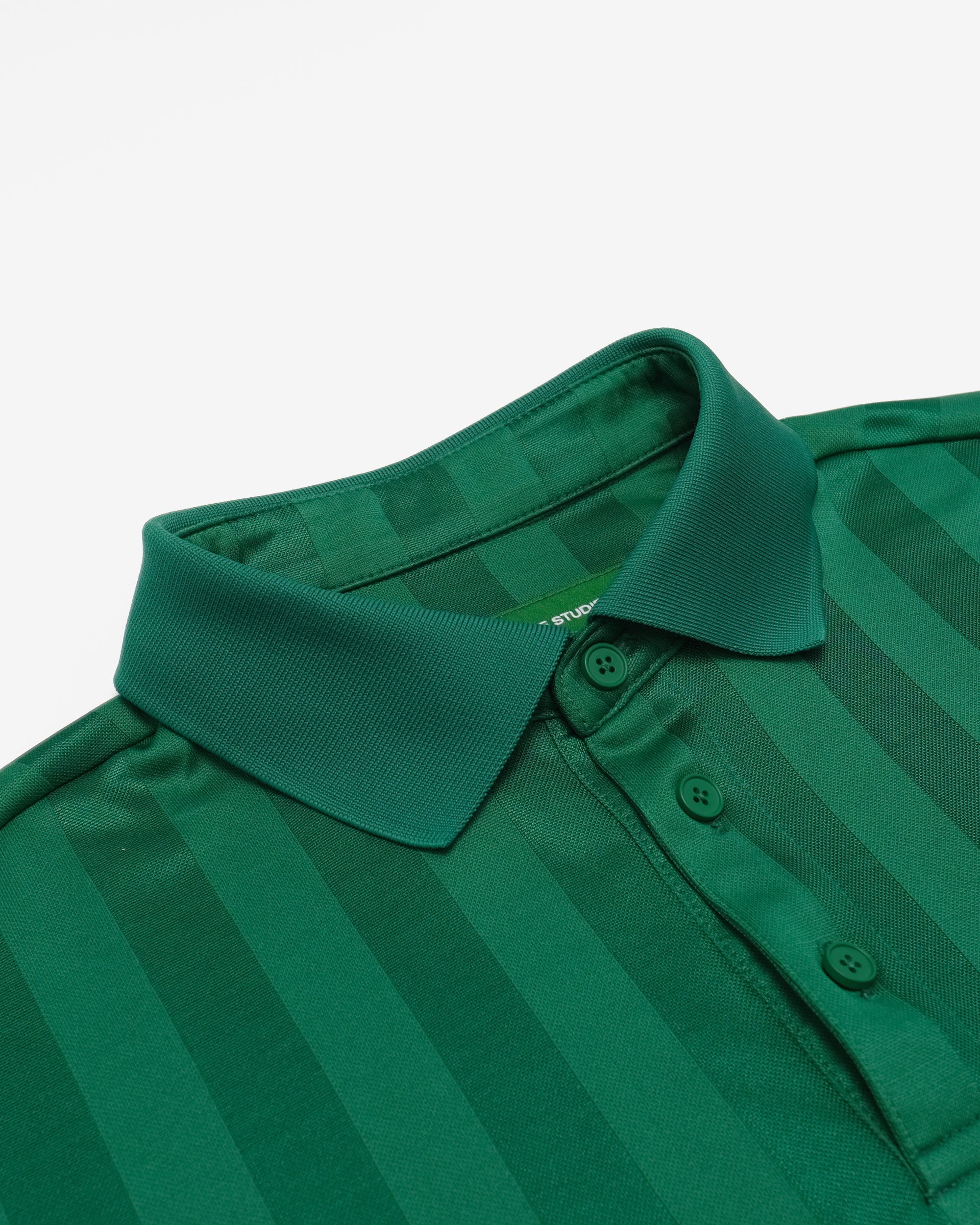 Green striped polo shirt on a light gray background