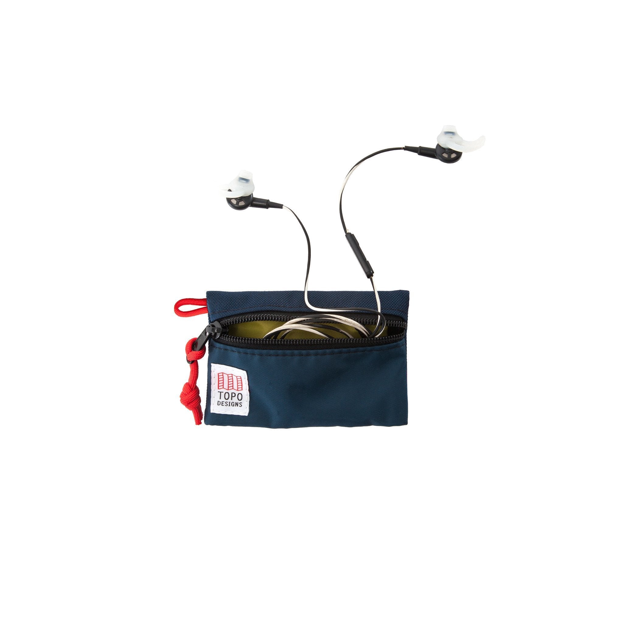 Detail shot of Topo Designs Accessory bags, organizer pouches for travel, showing headphones inside the micro navy blue bag.