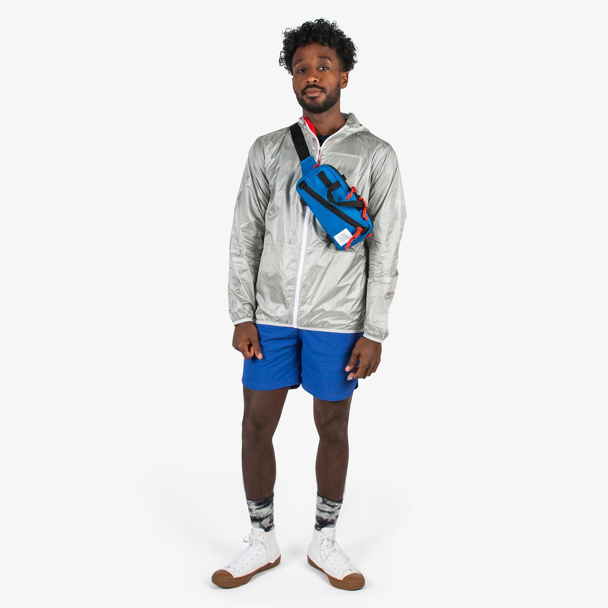 Topo Designs Mini Quick Pack in Blue worn crossbody on model.