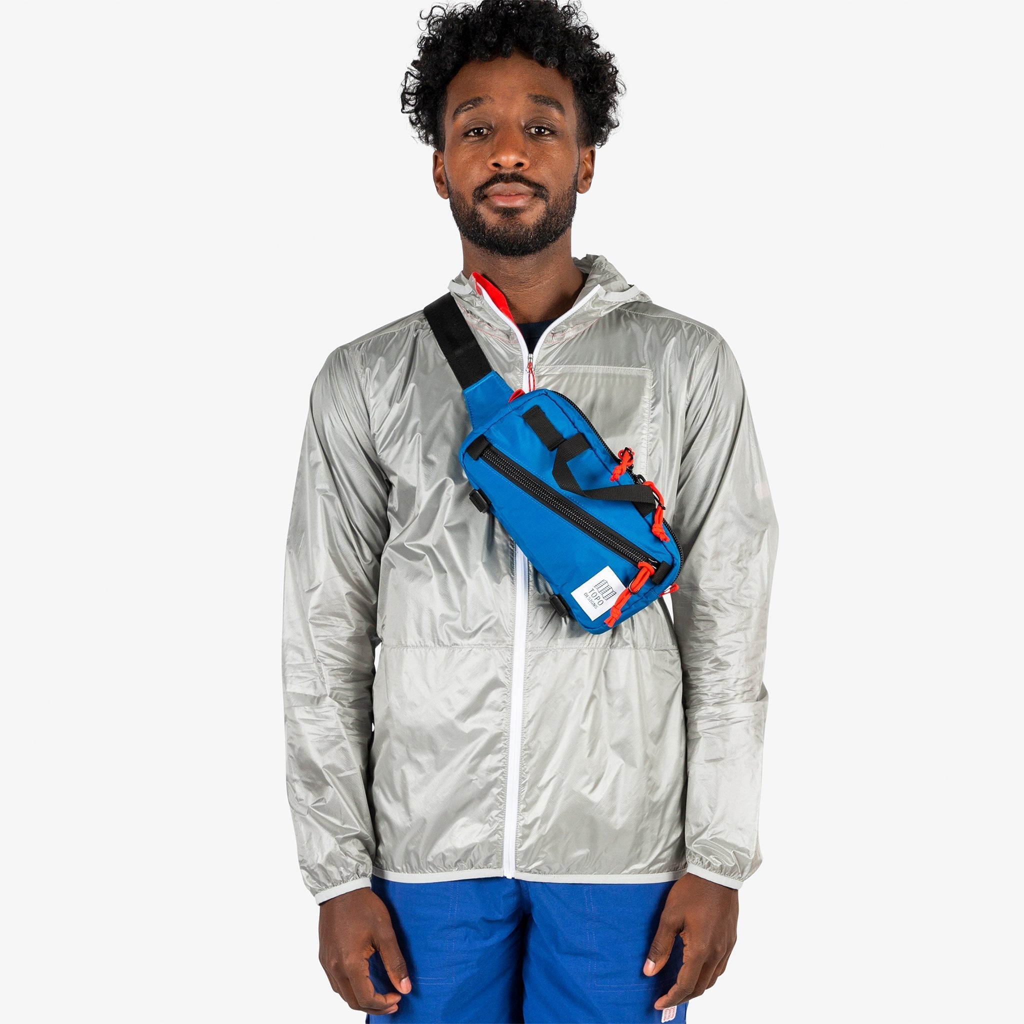 Topo Designs Mini Quick Pack in Blue worn crossbody on model.