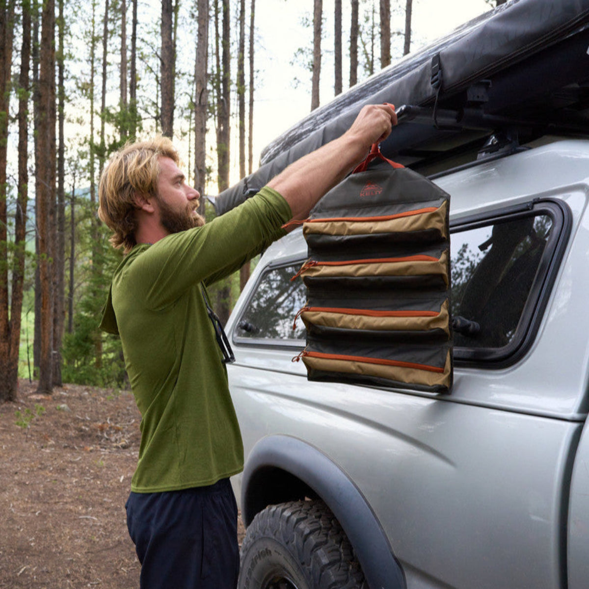 Man attaching Kelty Chef Roll to his roof rack