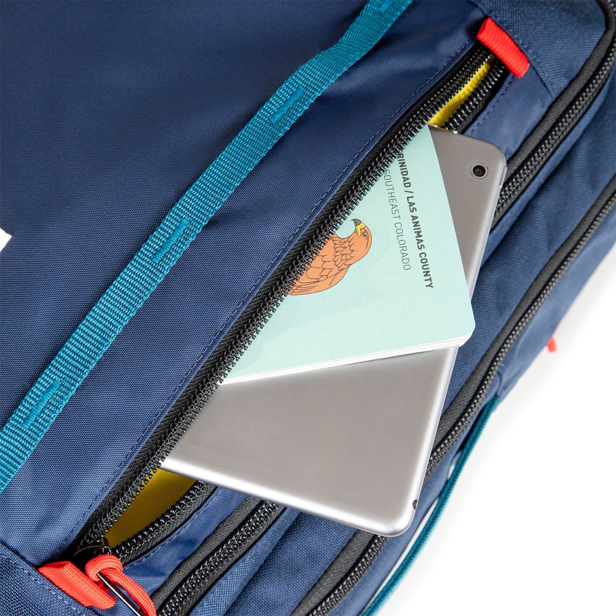 Topo Designs Global Travel Bag 40L Durable Carry On Convertible Laptop Travel Backpack in Navy blue showing front zipper pocket.