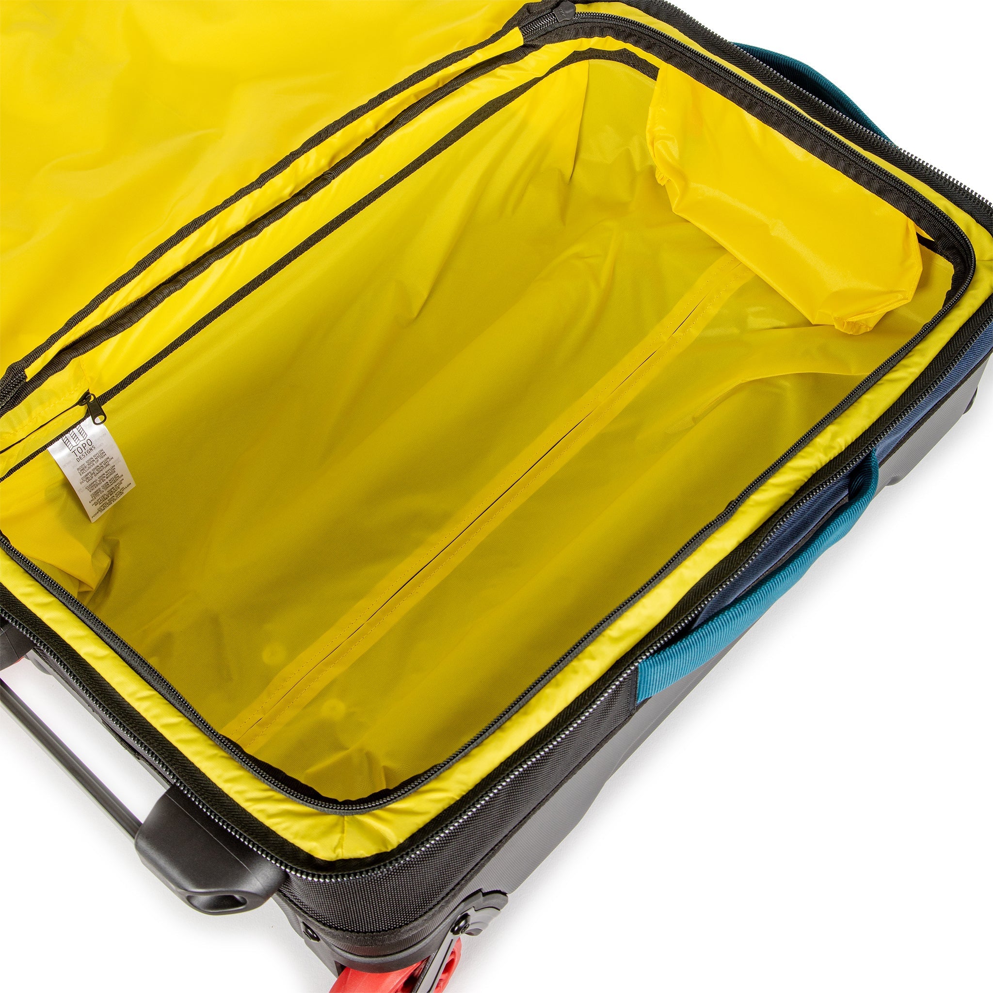 Yellow interior compartment of Topo Designs Global Travel Bag Roller durable carry-on convertible laptop rolling backpack suitcase in Navy blue.