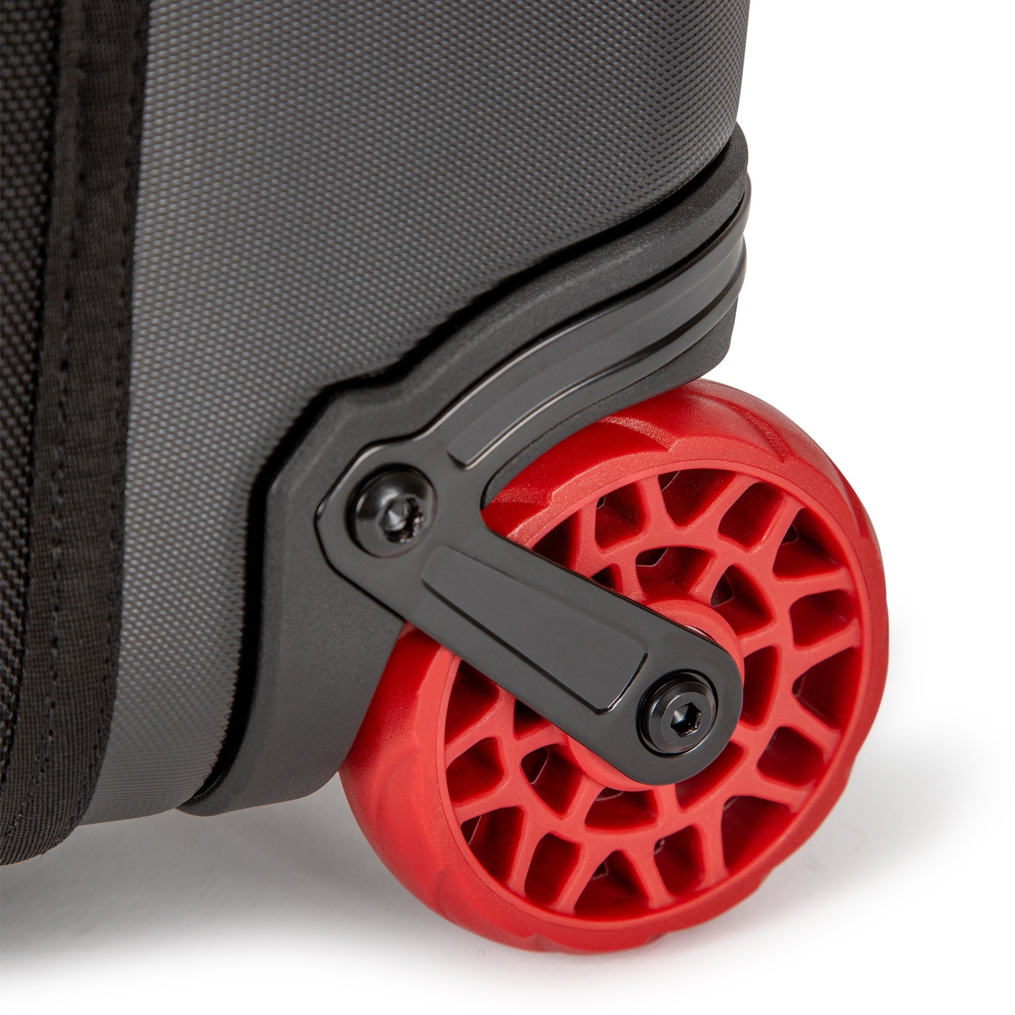 Durable red wheels on Topo Designs Global Travel Bag Roller durable carry-on convertible laptop backpack rolling suitcase.