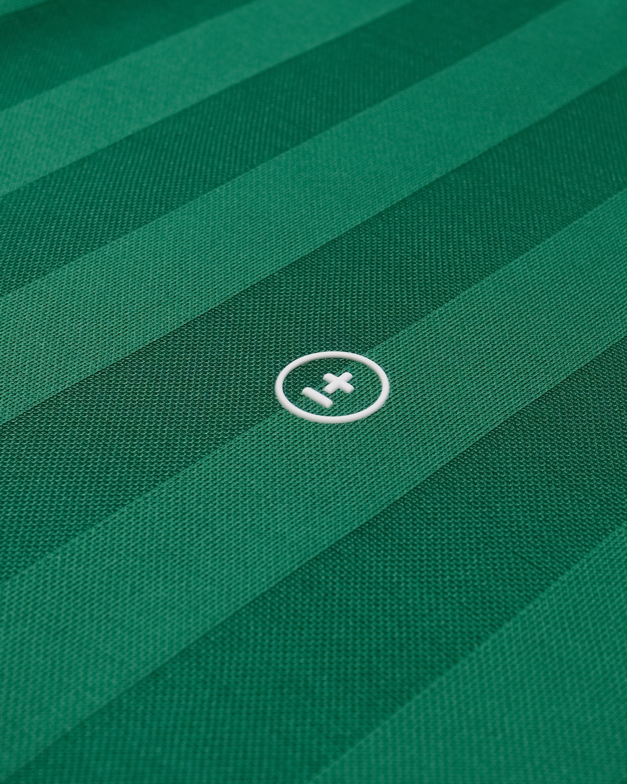 Close-up of a green fabric with a logo in the center